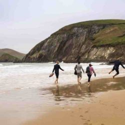 Group walking along the shore, Dingle, Kerry