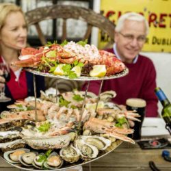 Group of friends having a seafood platter outside of Johnnie Fox's pub, Dublin